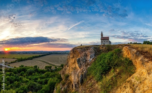 Historic roman church on the hill over village Drazovce near Nitra city at Slovakia and breathtaking colorful sunset
