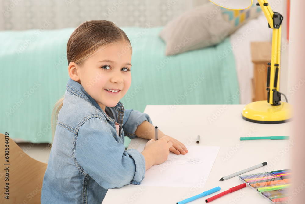 Cute little girl drawing with marker at desk in room. Home workplace Cute little girl drawing with marker at desk in room. Home workplace