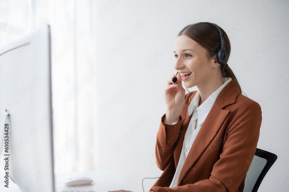 Call center agent woman with headset working on support hotline in modern office. Smiling female customer support phone operator at workplace. Call center agent woman with headset working on support hotline in modern office. Smiling female customer support phone operator at workplace.
