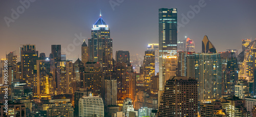 Night cityscape skyline Bangkok panorama of modern illuminated skyscraper in Bangkok city with glowing buildings in dusk in downtown. High-angle view on colorful Metropolis lights in twilight