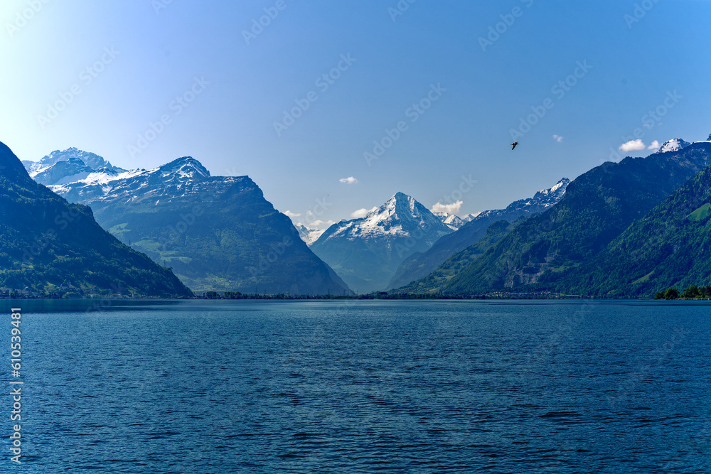Scenic view of Lake Lucerne with mountain panorama in the background on a sunny spring day. Photo taken May 22nd, 2023, Sisikon, Switzerland.