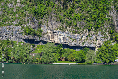 Scenic view of rock with cliff and road at lakeshore of Lake Lucerne . Photo taken May 22nd, 2023, Sisikon, Switzerland. photo