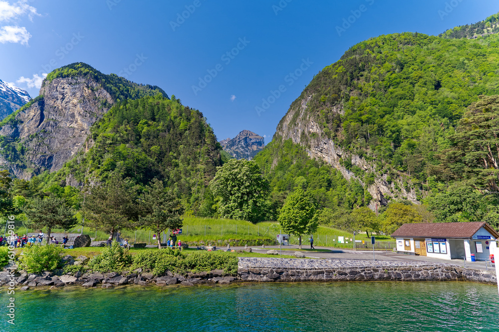 Fototapeta premium Scenic view of Lake Lucerne with mountain panorama in the background on a sunny spring day. Photo taken May 22nd, 2023, Sisikon, Switzerland.