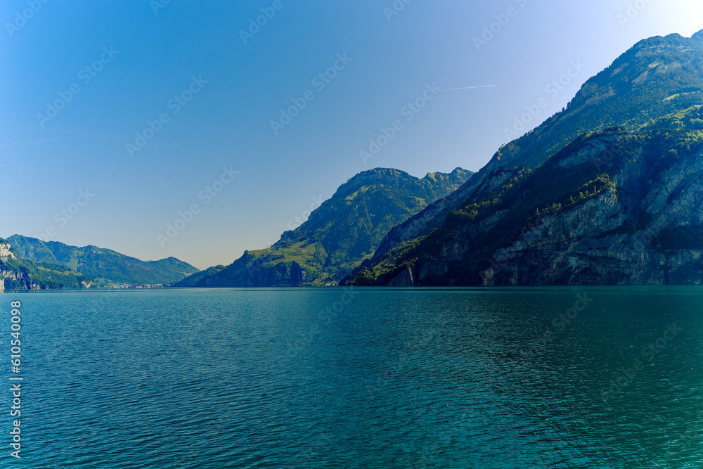 Scenic landscape with Lake Lucerne and mountain panorama in the Swiss Alps on a sunny spring day. Photo taken May 22nd, Sisikon, Canton Uri, Switzerland. Scenic landscape with Lake Lucerne and mountain panorama in the Swiss Alps on a sunny spring day. Photo taken May 22nd, Sisikon, Canton Uri, Switzerland.