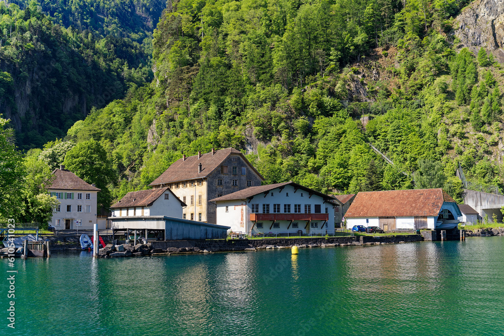 View of Lake Uri with beautiful mountain panorama and  pier at village Bauen on a sunny spring day. Photo taken May 22nd, 2023, Bauen, Switzerland.