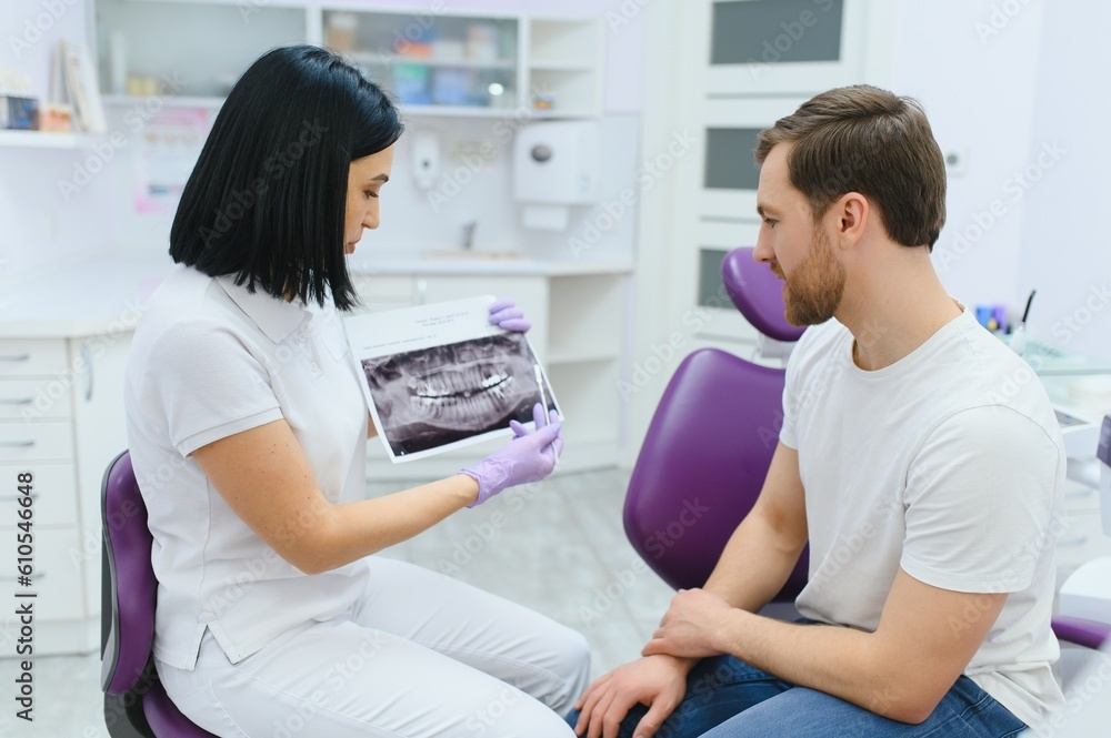 female dentist with male patient at clinic female dentist with male patient at clinic