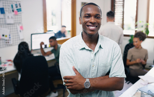 Black man, happy and portrait of designer with arms crossed in office workplace for business. Face, confidence and graphic design, African male person and entrepreneur, professional and leadership.