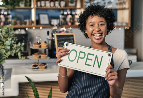 Happy woman, open sign and portrait of waitress at cafe in small business, morning or ready to serve. Female person, restaurant owner or server holding board for coffee shop or cafeteria opening