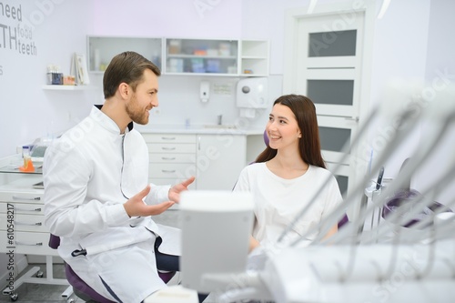 people  medicine  stomatology and health care concept - woman patient talking to male dentist and complain of toothache at dental clinic office.