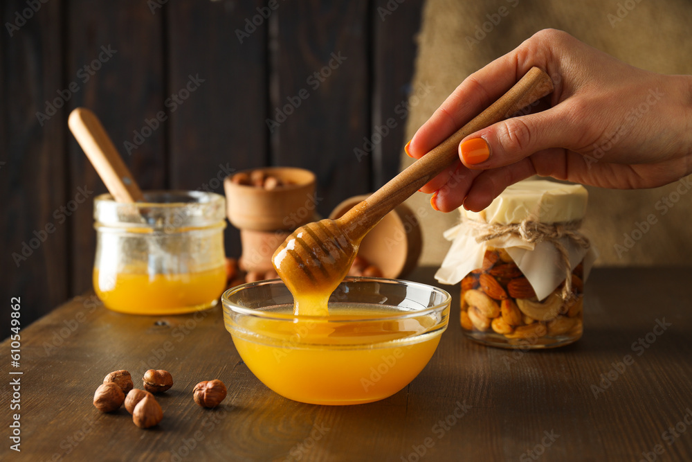 Concept of tasty and sweet food - honey with nuts Concept of tasty and sweet food - honey with nuts