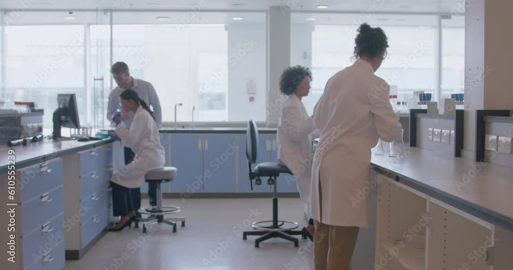 Scientist Working in Busy Pharmaceutical Laboratory in Hospital Scientist Working in Busy Pharmaceutical Laboratory in Hospital