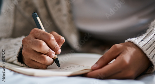 Notebook, bed and person hands for planning, brainstorming and studying notes, education and creativity. Journal, goals and student in bedroom zoom for home learning, plan schedule and reminder