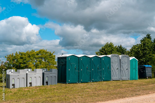 Portable mobile toilets and plastic hand washing sink stations on the public park