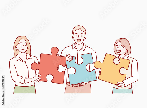 Teamwork and collaboration concept with four diverse multiracial people with puzzle pieces trying to find a solution together. Hand drawn style vector design illustrations.