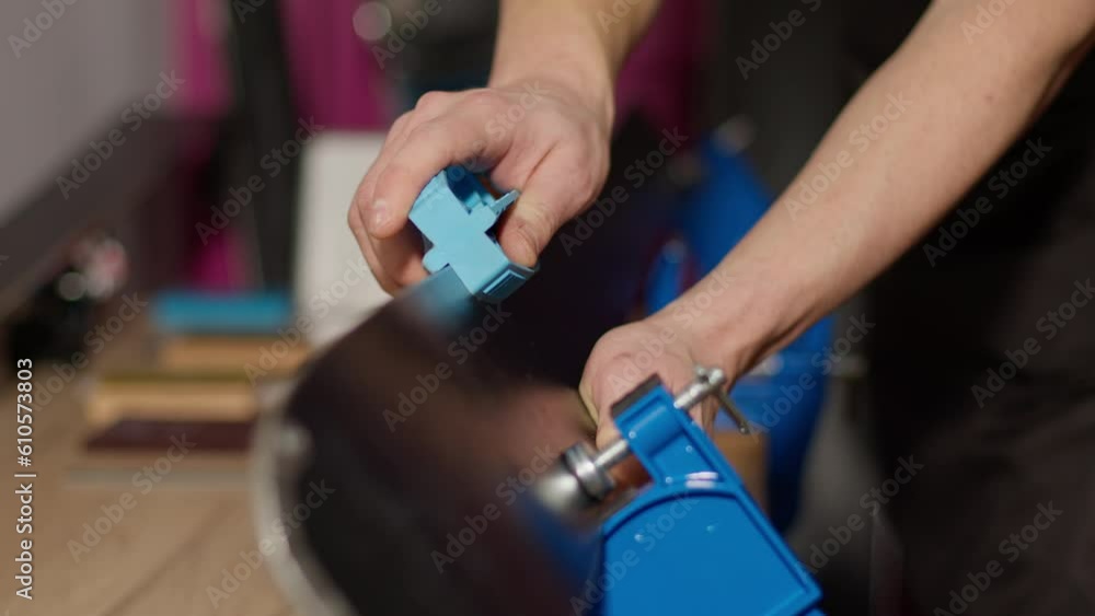 Man sharping ski edges with sharpening tool Man sharping ski edges with sharpening tool