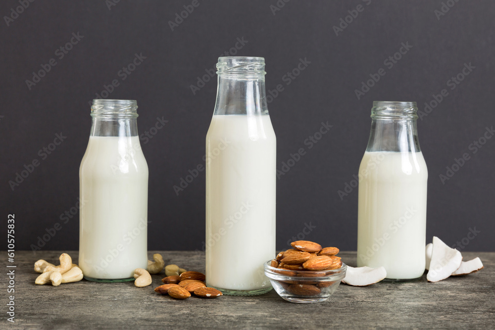 Set or collection of various vegan milk almond, coconut, cashew, on table background. Vegan plant based milk and ingredients, top view Set or collection of various vegan milk almond, coconut, cashew, on table background. Vegan plant based milk and ingredients, top view