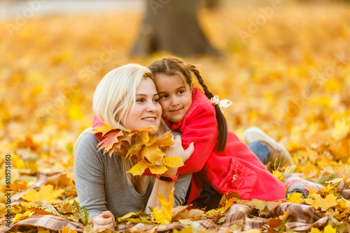 happy family mother and child daughter playing and laughing on autumn walk.