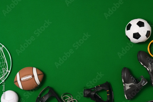 Frame of sports equipments on green grass flat lay, Space for text