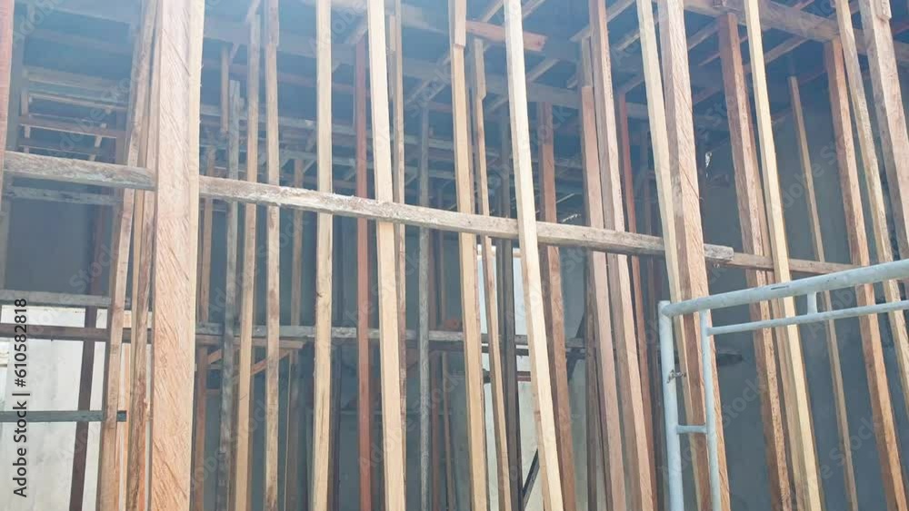 Wooden scaffolding being used by builders for new house build on a construction site in Southeast Asia Wooden scaffolding being used by builders for new house build on a construction site in Southeast Asia
