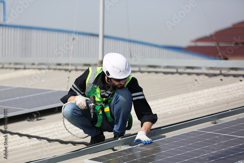 professional technician or engineer installing solar panels, Alternative energy for installed solar panels in use on roof of home
