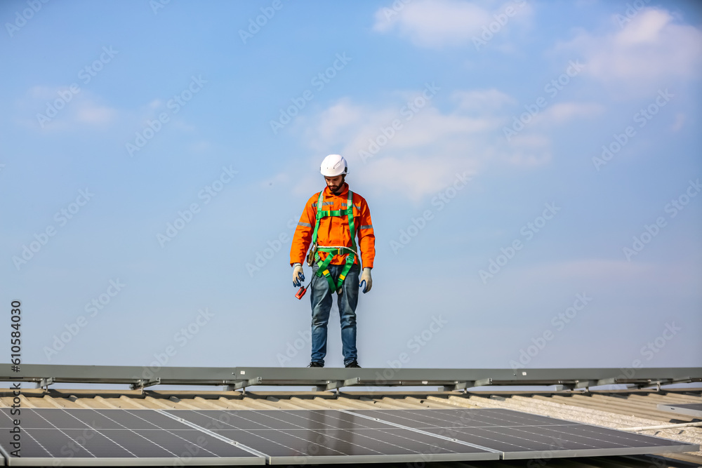 professional technician or engineer installing solar panels, Alternative energy for installed solar panels in use on roof of home