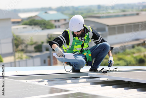 professional technician or engineer installing solar panels, Alternative energy for installed solar panels in use on roof of home