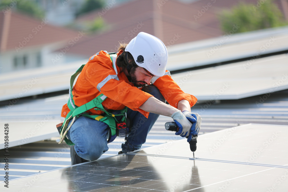 professional technician or engineer installing solar panels, Alternative energy for installed solar panels in use on roof of home professional technician or engineer installing solar panels, Alternative energy for installed solar panels in use on roof of home