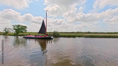 The traditional Norfolk wherry Albion transporting passengers along the River Bure, Norfolk Broads. Captured on a bright summer day