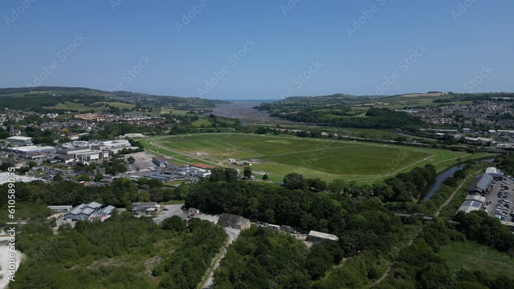 Newton Abbot, South Devon, England: DRONE VIEWS: The drone descends for views of Newton Abbot racecourse and the River Teign in the foreground right and distance (Clip 4). Newton Abbot, South Devon, England: DRONE VIEWS: The drone descends for views of Newton Abbot racecourse and the River Teign in the foreground right and distance (Clip 4).