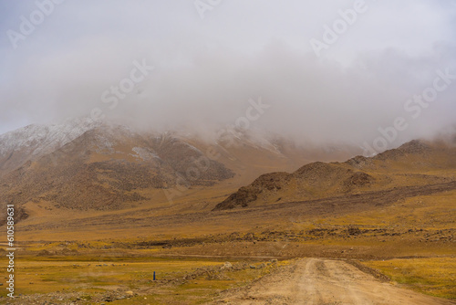 dry desert, withered grass field, the mountain and cloud sky at Tso Kar lake, Beautiful scenery along the way at Ladakh, India. The Tso Kar or Tsho kar is a fluctuating salt lake