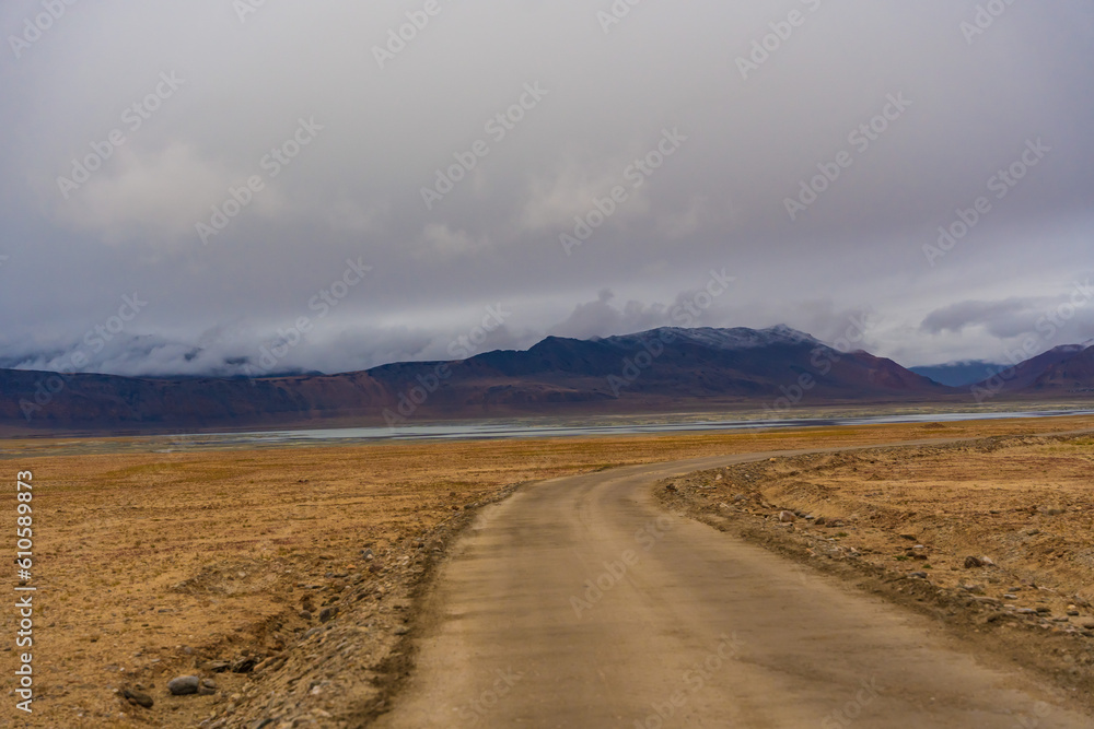 the road, mountain and cloud sky at Tanglang La pass in Ladakh, India, is the second highest motorable road in the world at 5400m the road, mountain and cloud sky at Tanglang La pass in Ladakh, India, is the second highest motorable road in the world at 5400m