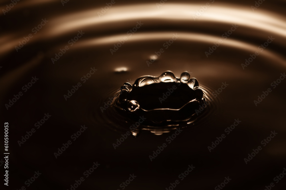 Water splash. waves diverging after the fall of the drop. shallow depth of fields, selective focus, macro view