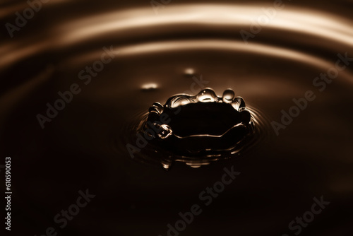 Water splash. waves diverging after the fall of the drop. shallow depth of fields, selective focus, macro view