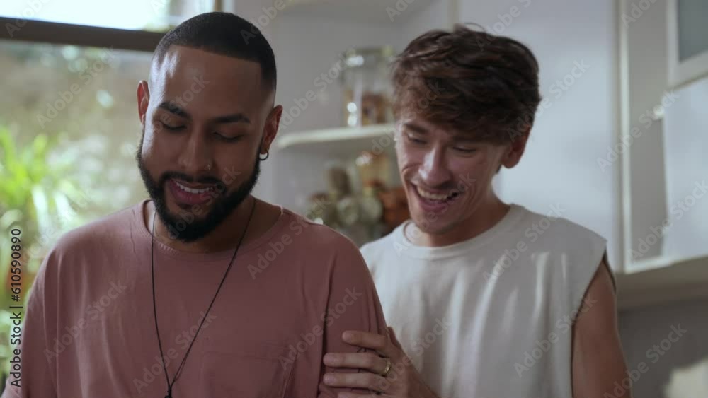black man talking to his white boyfriend in the kitchen while cutting vegetables on valentine's day black man talking to his white boyfriend in the kitchen while cutting vegetables on valentine's day