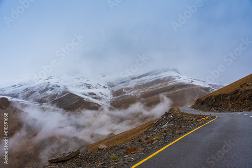 The road, Snow covered mountains, cloudy sky at Taglang La Pass, Keylong-Leh Road, the way from Moriri lake to Manali town, Ladakh, India photo