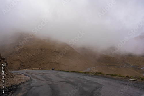 The road, Snow covered mountains, cloudy sky at Taglang La Pass, Keylong-Leh Road, the way from Moriri lake to Manali town, Ladakh, India