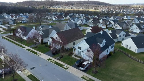 Large HOA neighborhood in USA. Aerial establishing shot of houses and homes in new development in late winter.