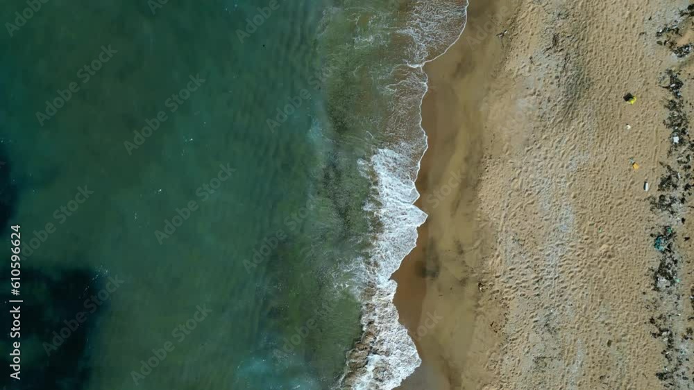turquoise waves on yellow sand - stock video from bird's eye view of a flying drone turquoise waves on yellow sand - stock video from bird's eye view of a flying drone