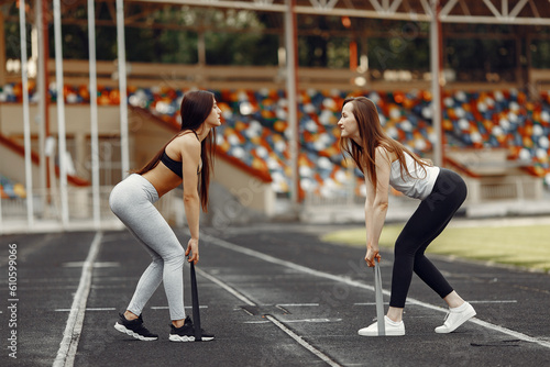 Two sports girls in a uniform training at the stadium
