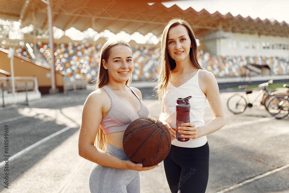 Sports girls in a uniform standing at the stadium