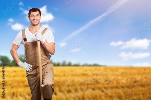 Happy young farmer on the agricultural field