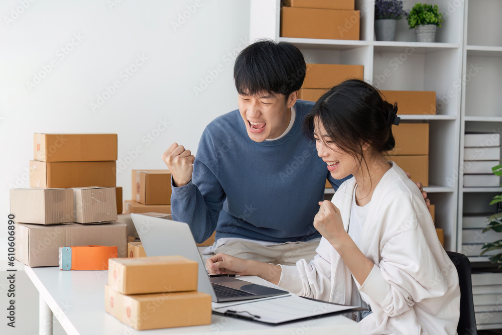 Image of Asian Happy couple people working in home. They are happy and success with their online store. Concept of freelancer startup and online business Image of Asian Happy couple people working in home. They are happy and success with their online store. Concept of freelancer startup and online business