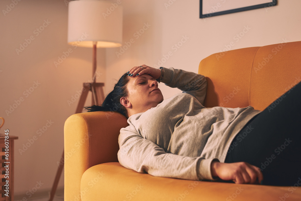 Fototapeta premium Woman with stomach and head pain at home.