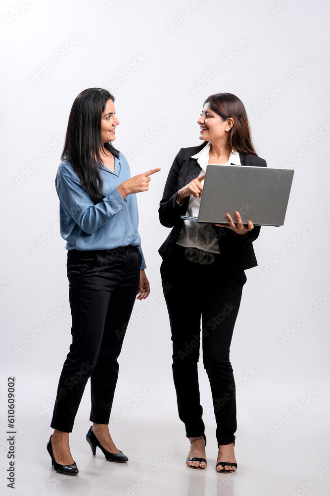 Two Young indian businesswoman watching some detail in laptop. Two Young indian businesswoman watching some detail in laptop.