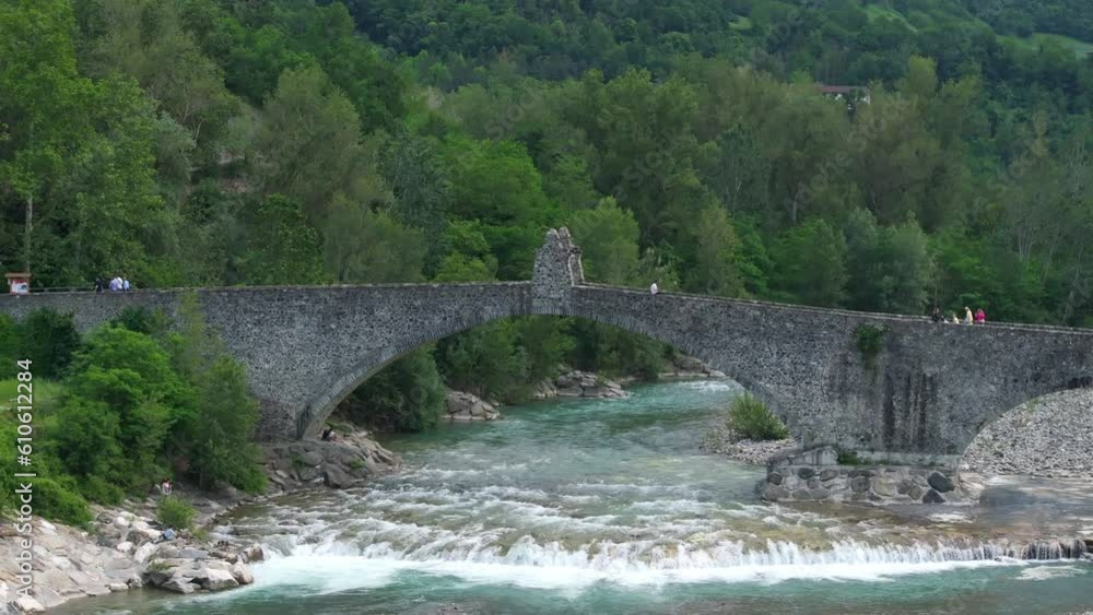 Gobbo bridge over Trebbia river, Bobbio in Italy. Aerial backward ascending Gobbo bridge over Trebbia river, Bobbio in Italy. Aerial backward ascending
