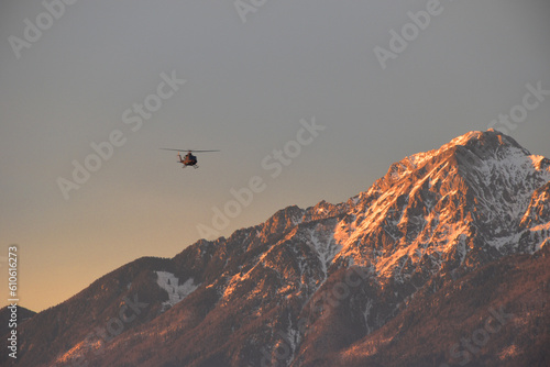 Helicopter fliying over Mount Storzic in Slovenia photo