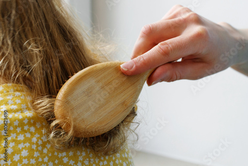 Close-up of a mother brushing her daughter's hair