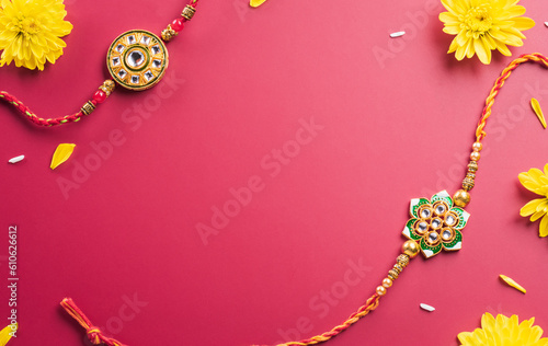 Raksha Bandhan, Indian festival with beautiful Rakhi, Rice Grains and flower. A traditional Indian wrist band which is a symbol of love between Sisters and Brothers