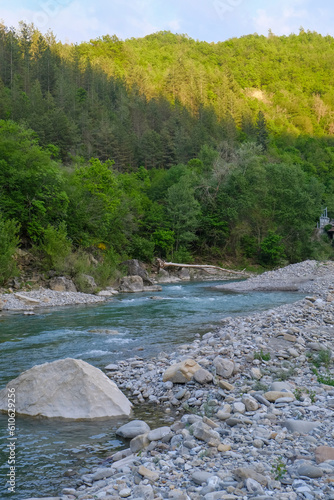 river Enza in the Apennines mountains in Parma, Emilia Romagna, Italy across mountains and forest in sunset lights. Travel, nature, trekking

