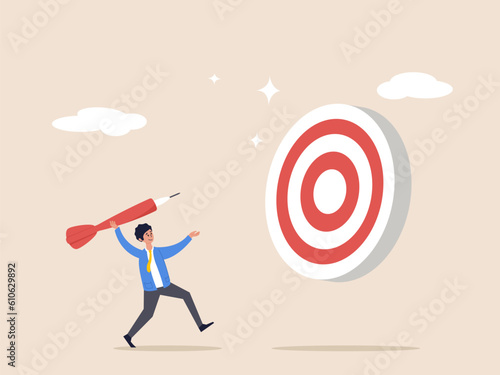 Business target concept. Aiming for big goal, challenge to achieve target, success or accuracy, ambition or determination to reach, businessman throwing huge dart, aiming to hit dartboard bullseye.